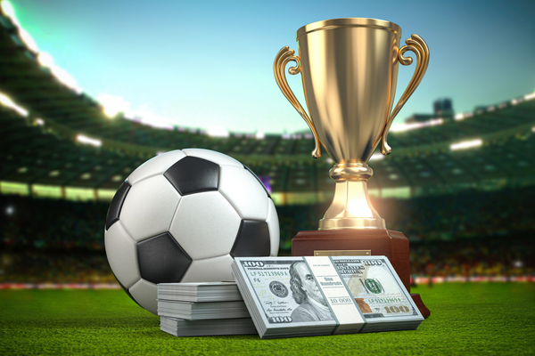 Betting,,Footbal,Ball,And,Cup,With,Packs,Of,Dollar,On